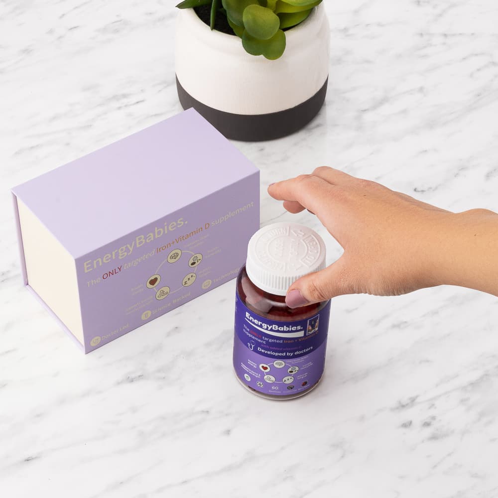Hand holding a beauty product bottle in a lifestyle photography composition at PMP studio
