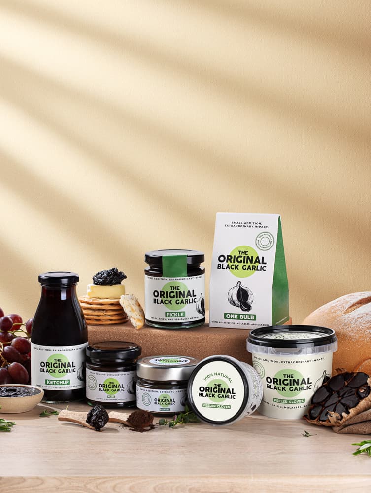 Black garlic product in styled scene - food lifestyle product photography UK