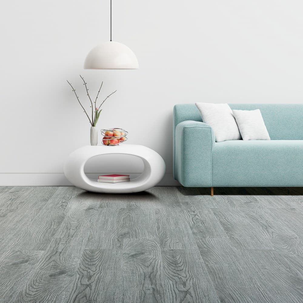 Grey wood-effect floor in a pale room with a blue sofa and low white table
