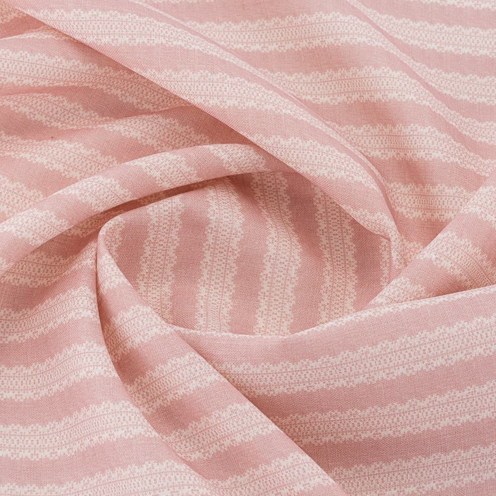 Pink and cream striped fabric arranged in folds to show its woven texture